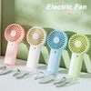 Five electric fans in various colors are displayed on a white surface with their charging cables.