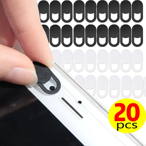 A hand is applying a privacy lens protector for a laptop or tablet, showing multiple protective covers.