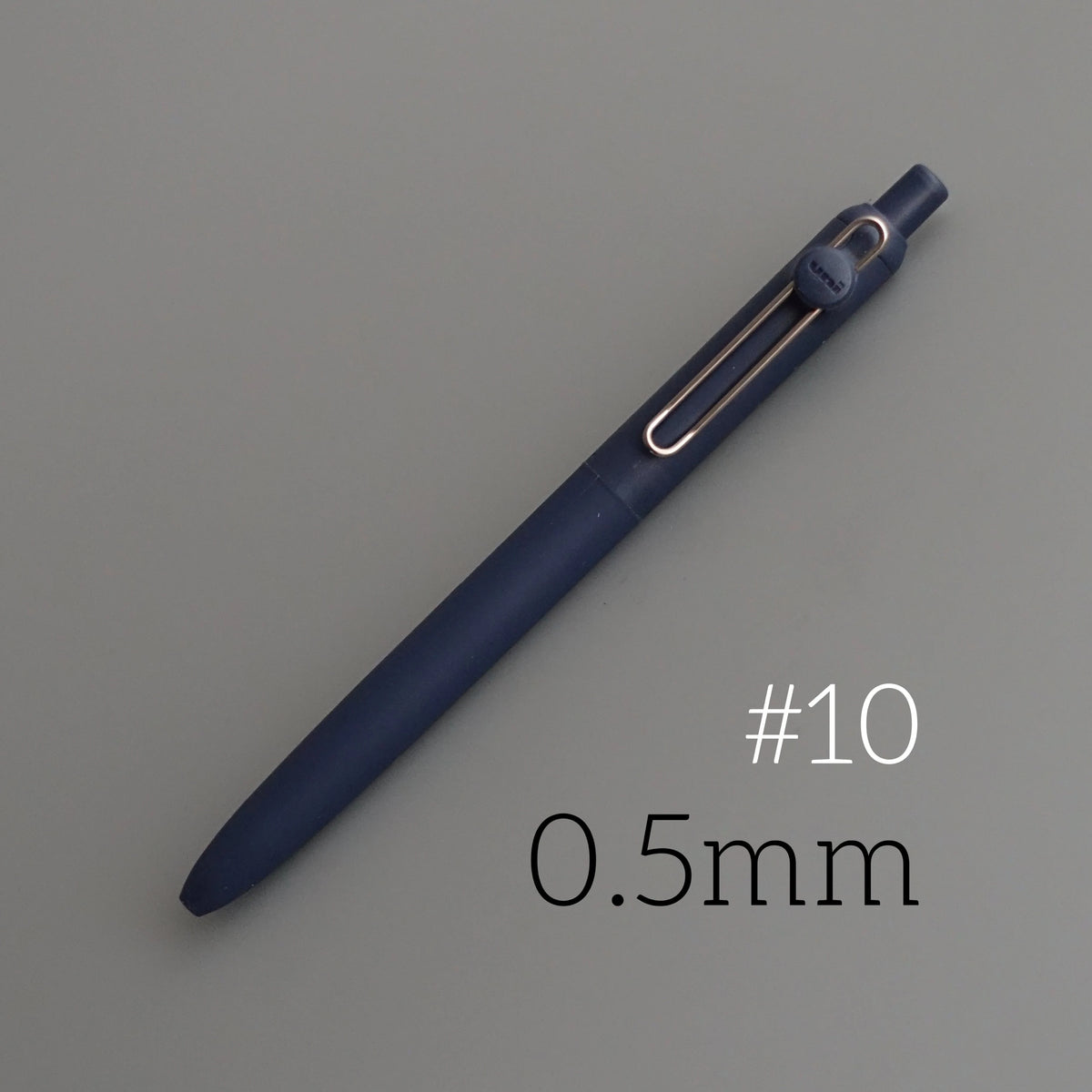 A dark blue precision gel pen with a gold-colored tip and a numbered marking #10 and 0.5mm size.
