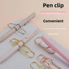 A collection of elegant metal pen clips in various colors, including gold and pink, displayed on a white surface.
