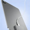 A silver iPad is shown with a magnetic wireless charging module attached, connected to a white charging cable.