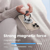 A hand holds a dual-sided magnetic phone ring holder demonstrating strong magnetic force for phone support.