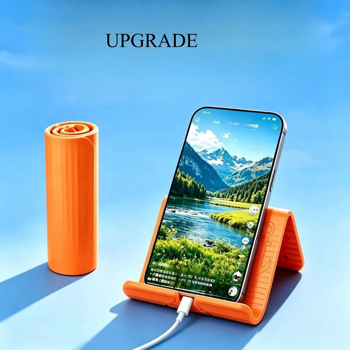 An orange flexible silicone phone stand holding a smartphone displaying a scenic mountain landscape.