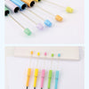 A collection of colorful DIY beadable pens with black ink shown in various shades and angles.