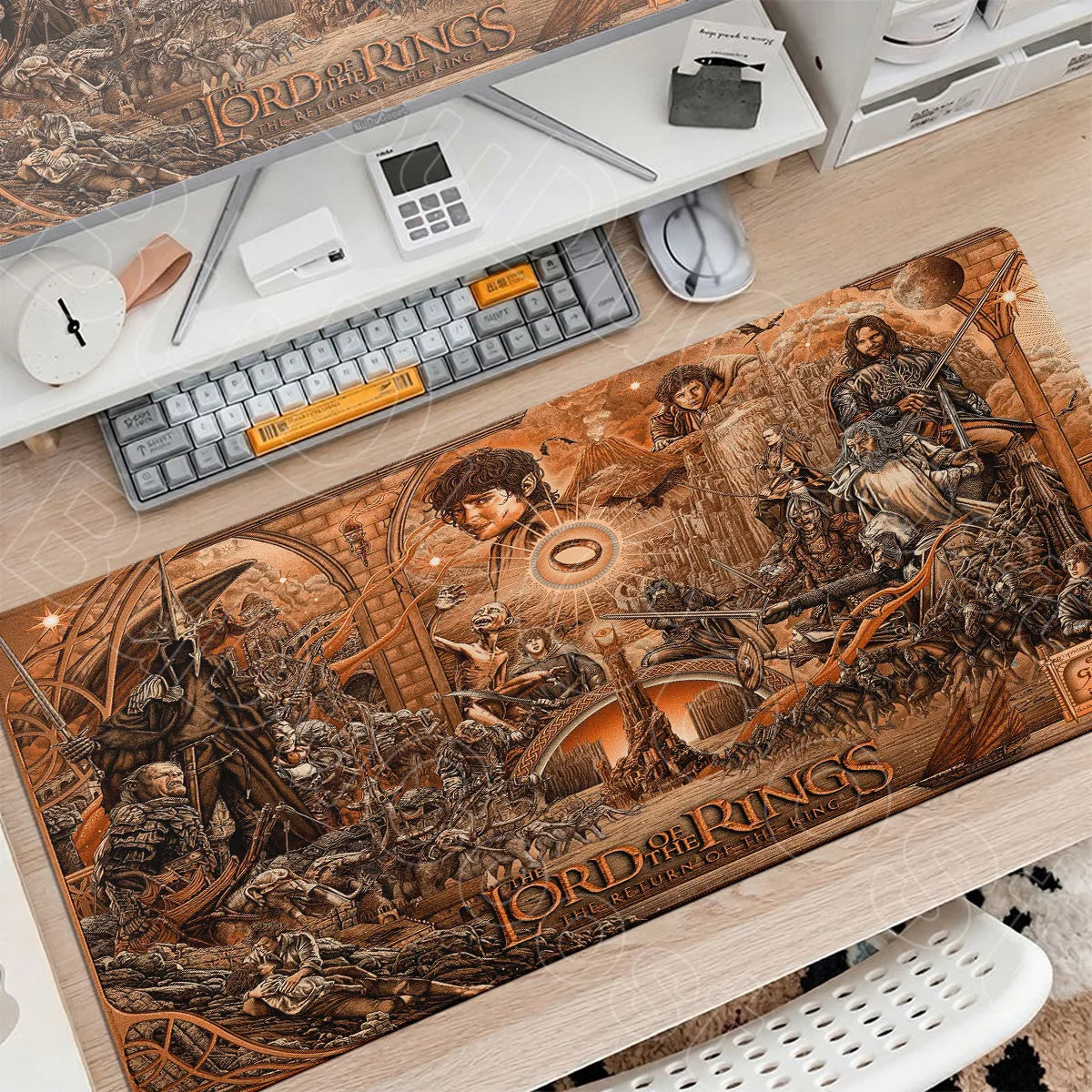 A large brown Lord of the Rings themed gaming mouse pad featuring a detailed battle scene and text.