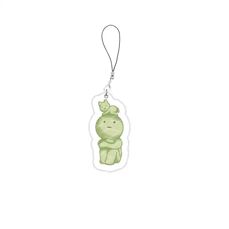 A small, green, squishy character charm on a silver keychain.