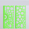 A transparent lime green multi-shape geometric drawing template ruler set with various shapes and measurements.