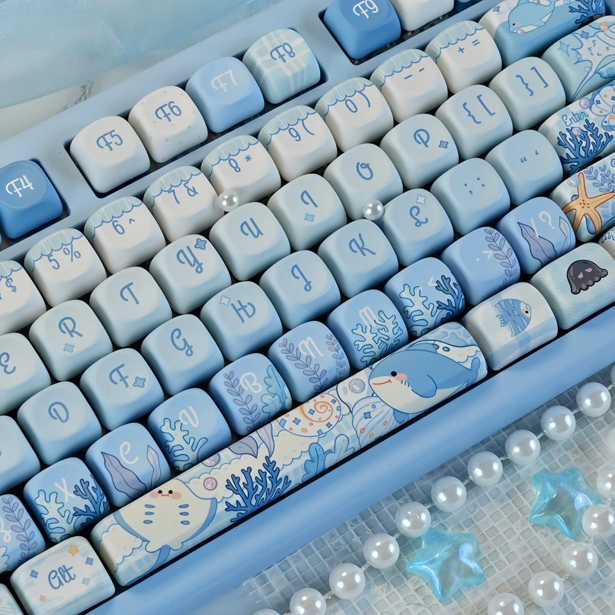 Blue sea themed PBT keycaps for a mechanical keyboard showing various light blue and white keys