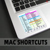 A close-up of a laptop showing a detailed Mac Shortcuts reference chart on the screen.