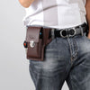Brown leather waist bag with a silver buckle worn on a dark blue denim jean pocket.