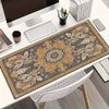 A vintage Persian rug design mouse pad with an ornate pattern is displayed on a white desk.