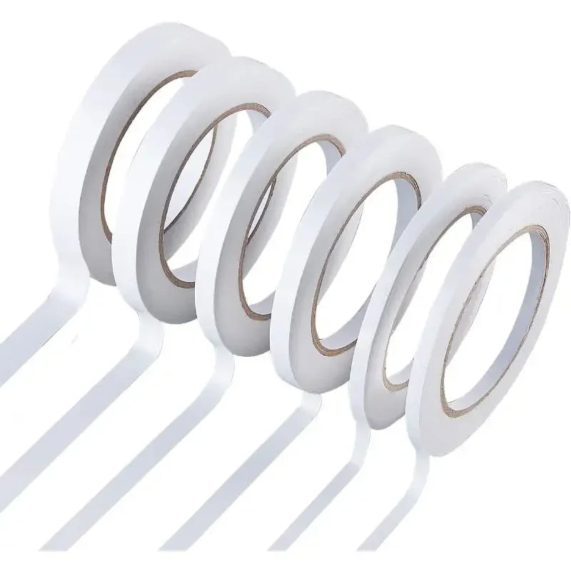 A set of two double-sided craft adhesive tapes rolled into circular discs.