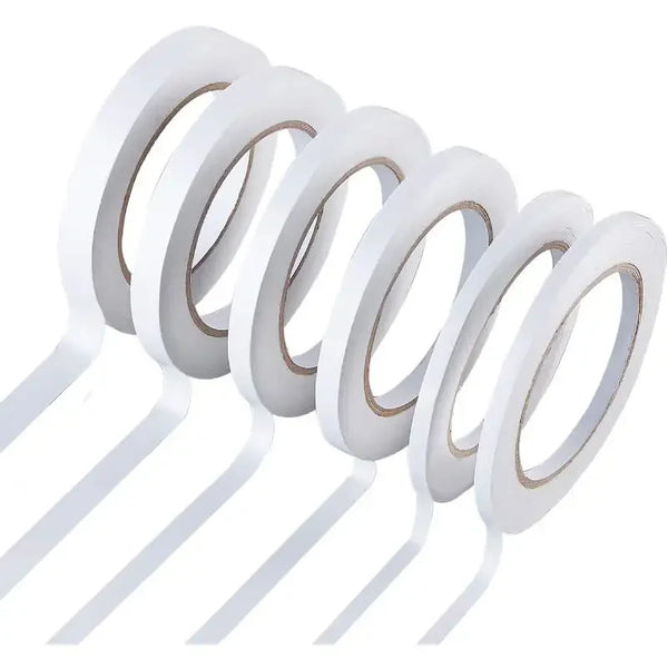 A set of two double-sided craft adhesive tapes rolled into circular discs.