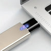 A silver USB-C to USB-A adapter is shown next to a white electronic device.