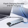 A silver 8-in-1 USB-C hub is shown connected to a laptop, demonstrating flash charging capabilities.