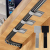 Reusable adhesive cable ties in silver and black are shown organized on a wooden desk surface.
