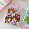 A colorful memo pad featuring cute animal characters and text that says Happy Shake