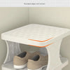 White plastic shoe rack displaying pairs of beige and black shoes.