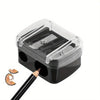 Afilador de lápices automático de plástico transparente con doble orificio, base negra y punta naranja.