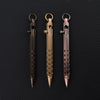 Three brass bolt-action ballpoint pens with gold accents displayed against a dark background.