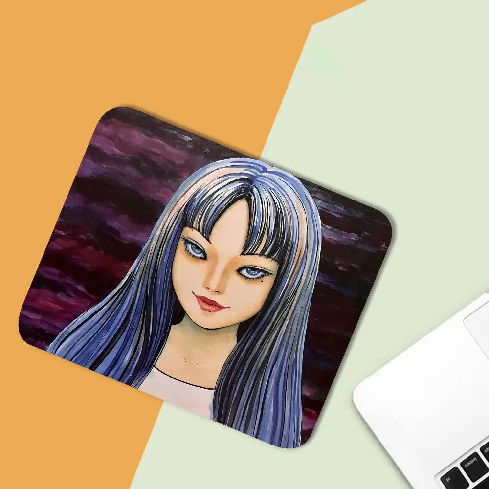 A mouse pad featuring a stylized illustration of the character Tomie from Junji Ito, with purple and blue hair.