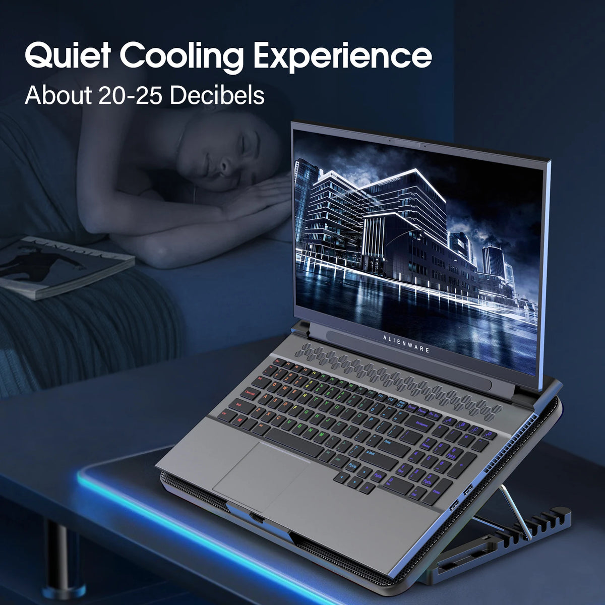 A silver laptop is placed on an adjustable cooling pad with blue LED lighting, next to a sleeping person.