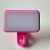 A pink portable rechargeable mini selfie light with a rectangular translucent panel and a pink clip.