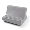 A gray multi-angle adjustable tablet and phone holder with ribbed cushioning.
