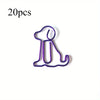 A purple paper clip shaped like a sitting dog, used as a cute desk organizer.