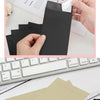 A hand is opening a black kraft paper self-adhesive envelope, showing the texture and closure mechanism.