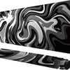 A black and gray liquid wave design gaming mouse pad shown from a side angle.