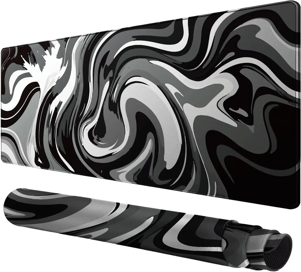 A black and gray liquid wave design gaming mouse pad shown from a side angle.