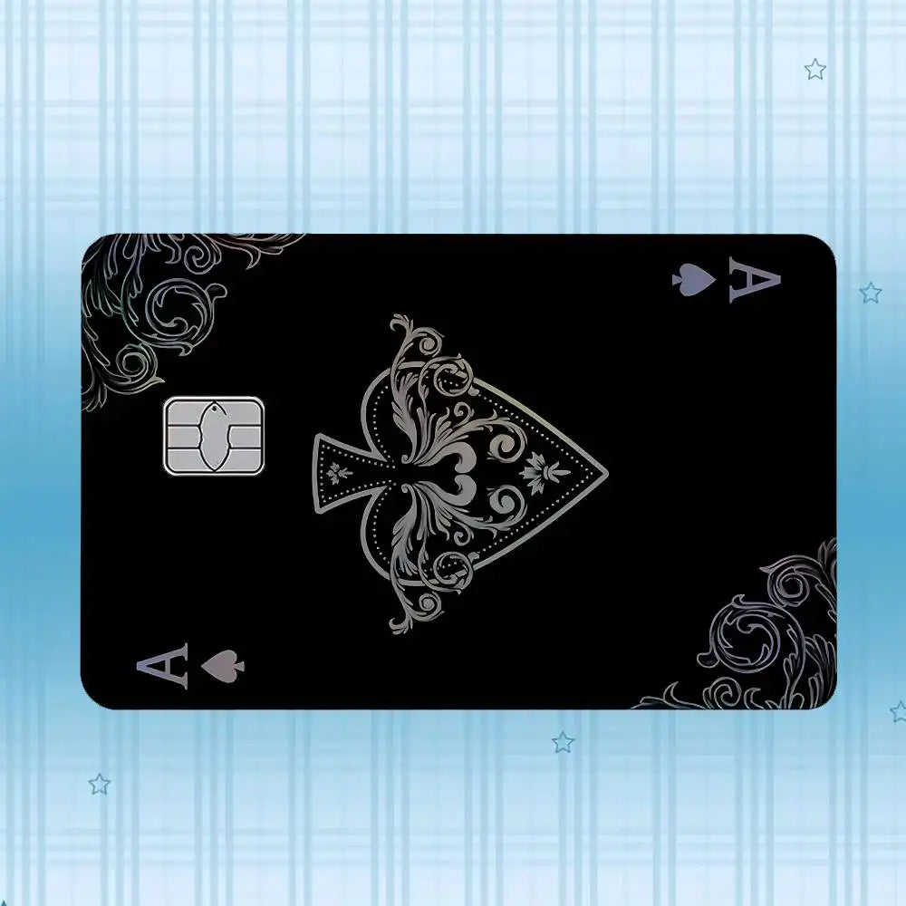 A black card featuring an ornate design and a gold-colored square emblem against a light blue striped background.