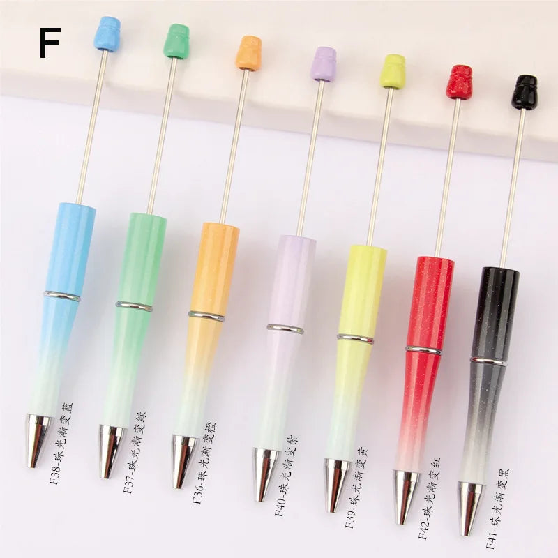 A set of 10 beadable pens with various colors and black ink tips displayed in a row.