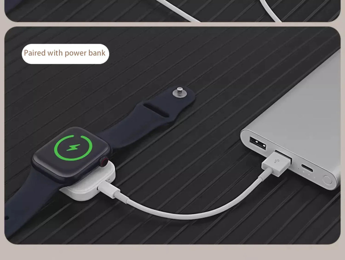 A smartwatch is shown being charged by a magnetic wireless charger connected to a power bank.