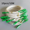 A coil of 10 single-mode fiber optic cables, 10 meters long, with green connectors.