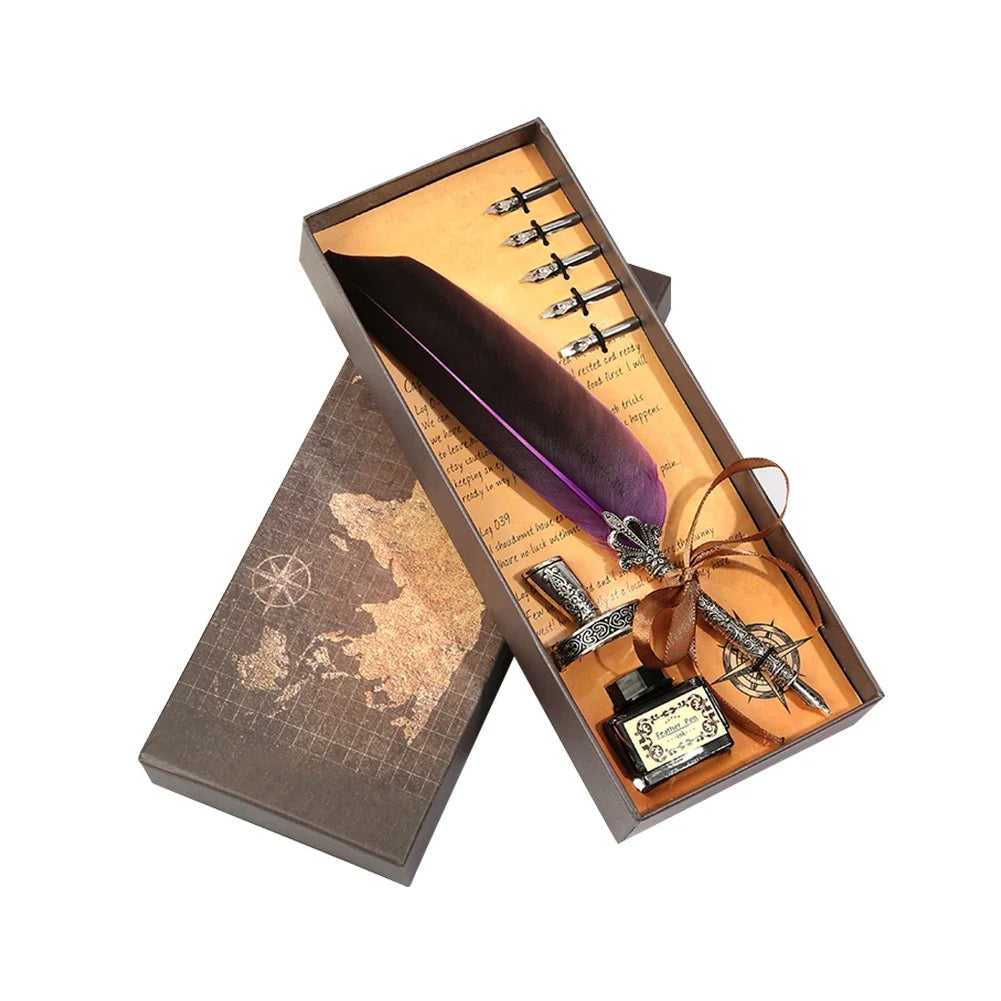 A wooden box containing a dip pen set with a purple feather and various tools for calligraphy.