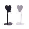 A black adjustable desktop phone and tablet stand with heart-shaped holders.