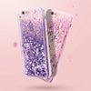 A clear phone case with a purple glitter heart design and pink accents shown against a light background.