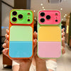 A hand holds an iPhone in a colorful block acrylic case featuring orange, green, blue, and pink sections.