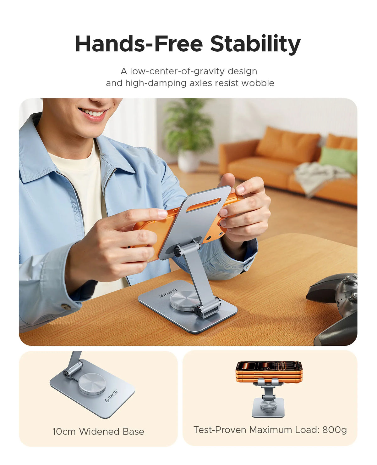 A person holds a orange phone holder stand on a wooden table demonstrating hands-free stability.