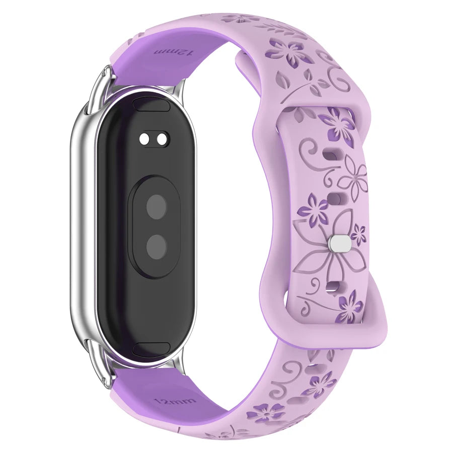 A purple silicone watch band with a black display and silver casing, featuring engraved flowers.