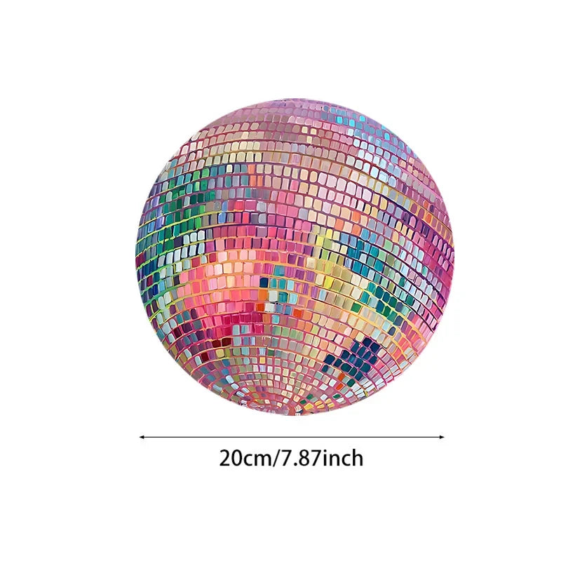 A spherical pink disco ball mouse pad with a non-slip rubber base featuring a mosaic of colorful squares.