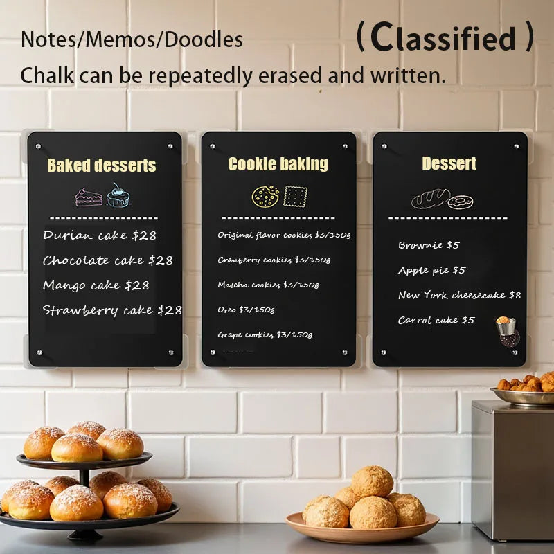 A set of three black magnetic planning boards with chalk writing surfaces for notes and memos, displaying baked desserts, coo