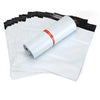 A roll of white self-adhesive sealed packing bags with an orange band, stacked and partially unwrapped.