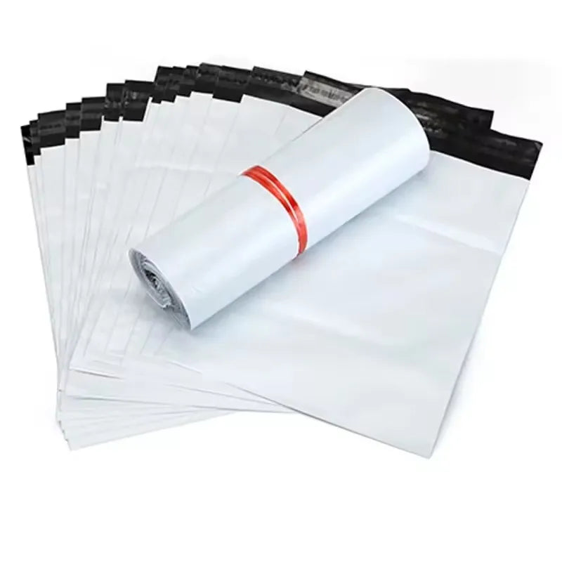 A roll of white self-adhesive sealed packing bags with an orange band, stacked and partially unwrapped.