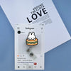 A white Instagram post featuring a Miffy rabbit badge reel attached to an ID card holder against a light background.