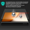 A close-up view of a tempered glass screen protector being applied to a tablet screen, showing a protective membrane and sphe