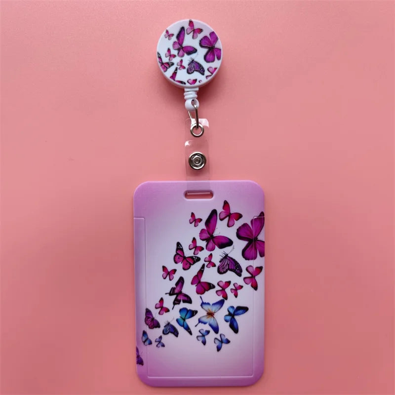 A purple phone case features a floral design, attached to a clip with a flower-shaped charm.