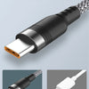 A black aluminum alloy USB-C cable with a braided nylon design shown next to an old, damaged cable.
